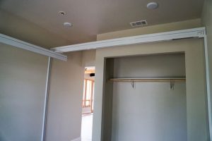 Wall to Wall Brackets are used where there is no attic access and the lift must be able to bear a weight of 600 lbs. The Wall Posts are attached to the wall studs using a higher capacity fixed track attached to the tops of the Wall Posts. The room shown has an X-Y System.